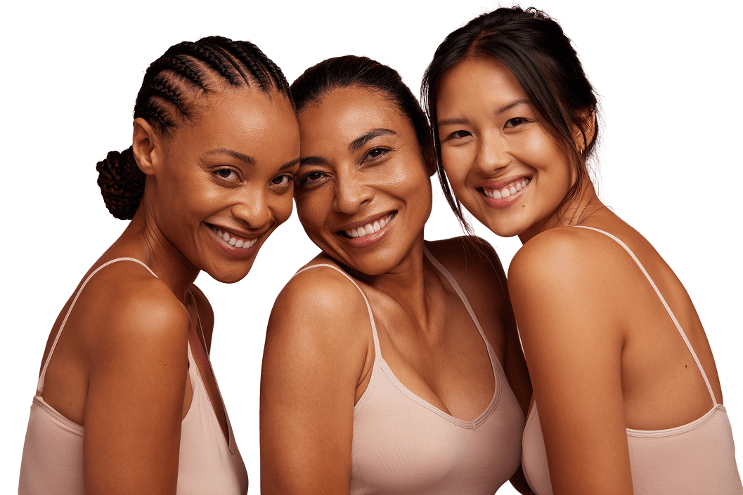 hero-img2321 Three women smiling for a picture in front of green background.