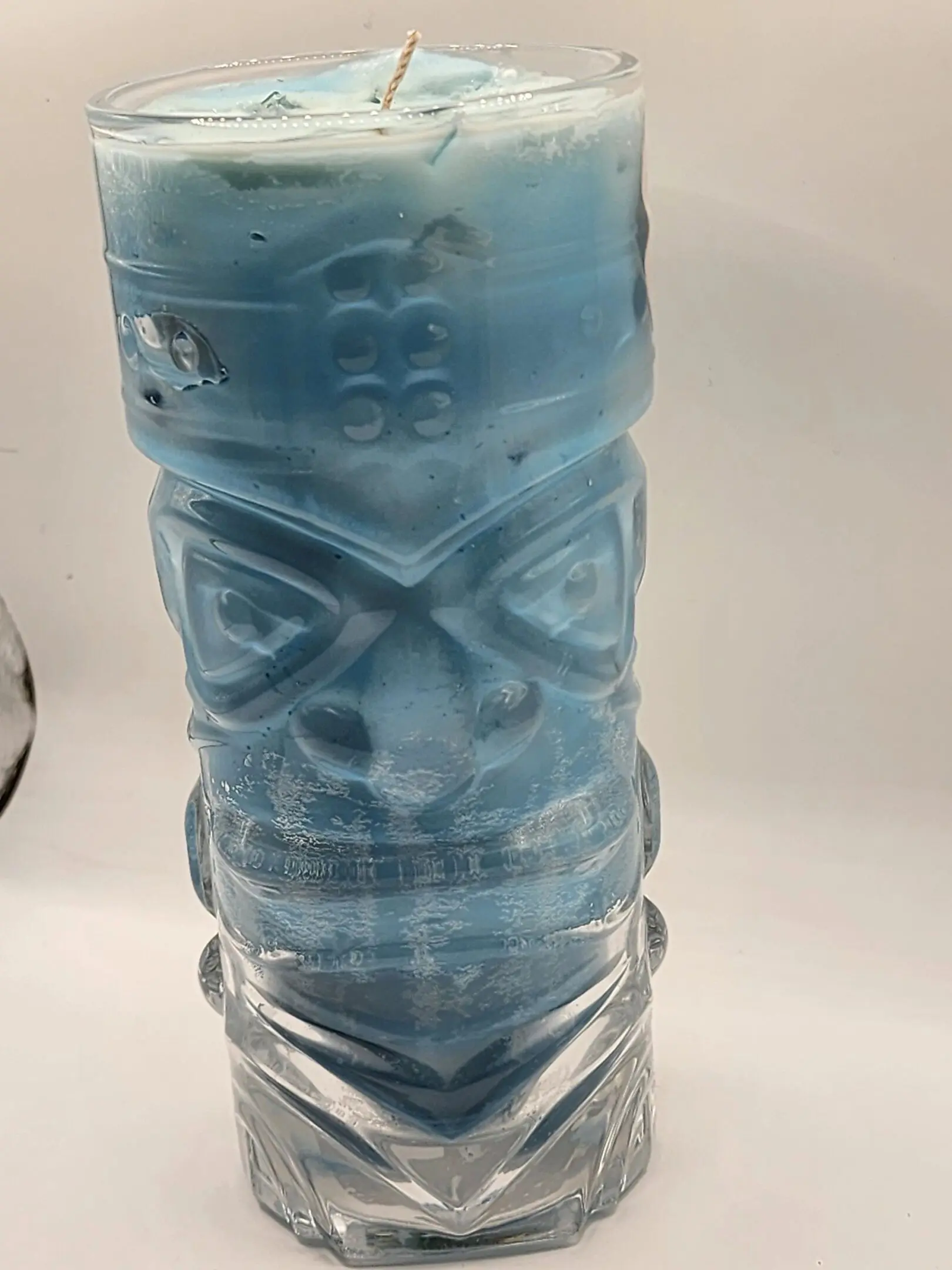 A glass with a blue face on it