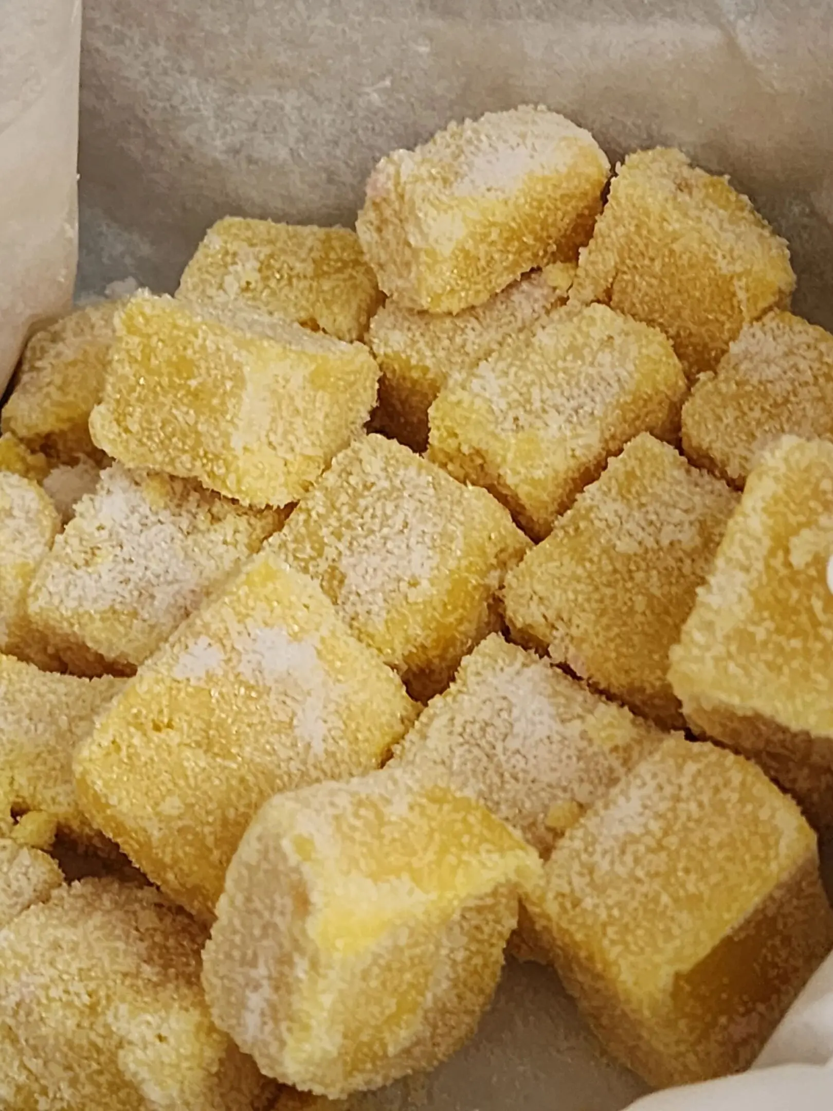 A close up of some yellow sugar cubes