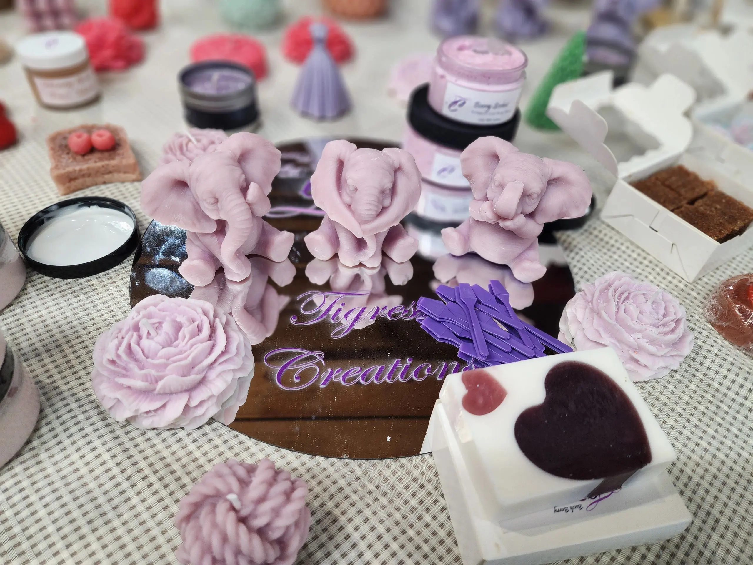 A table covered with various pink and purple items.