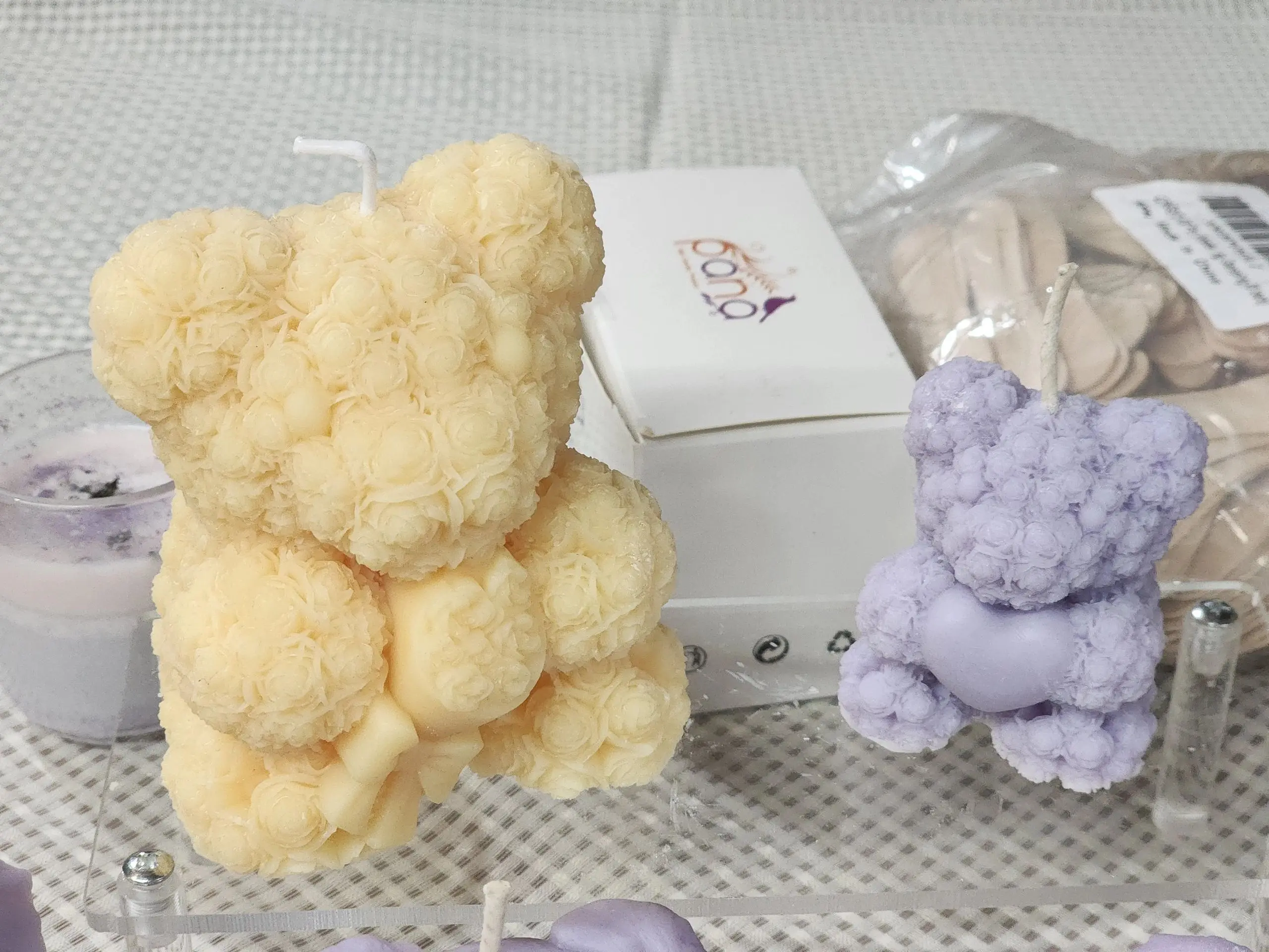 A table with some candles shaped like teddy bears.
