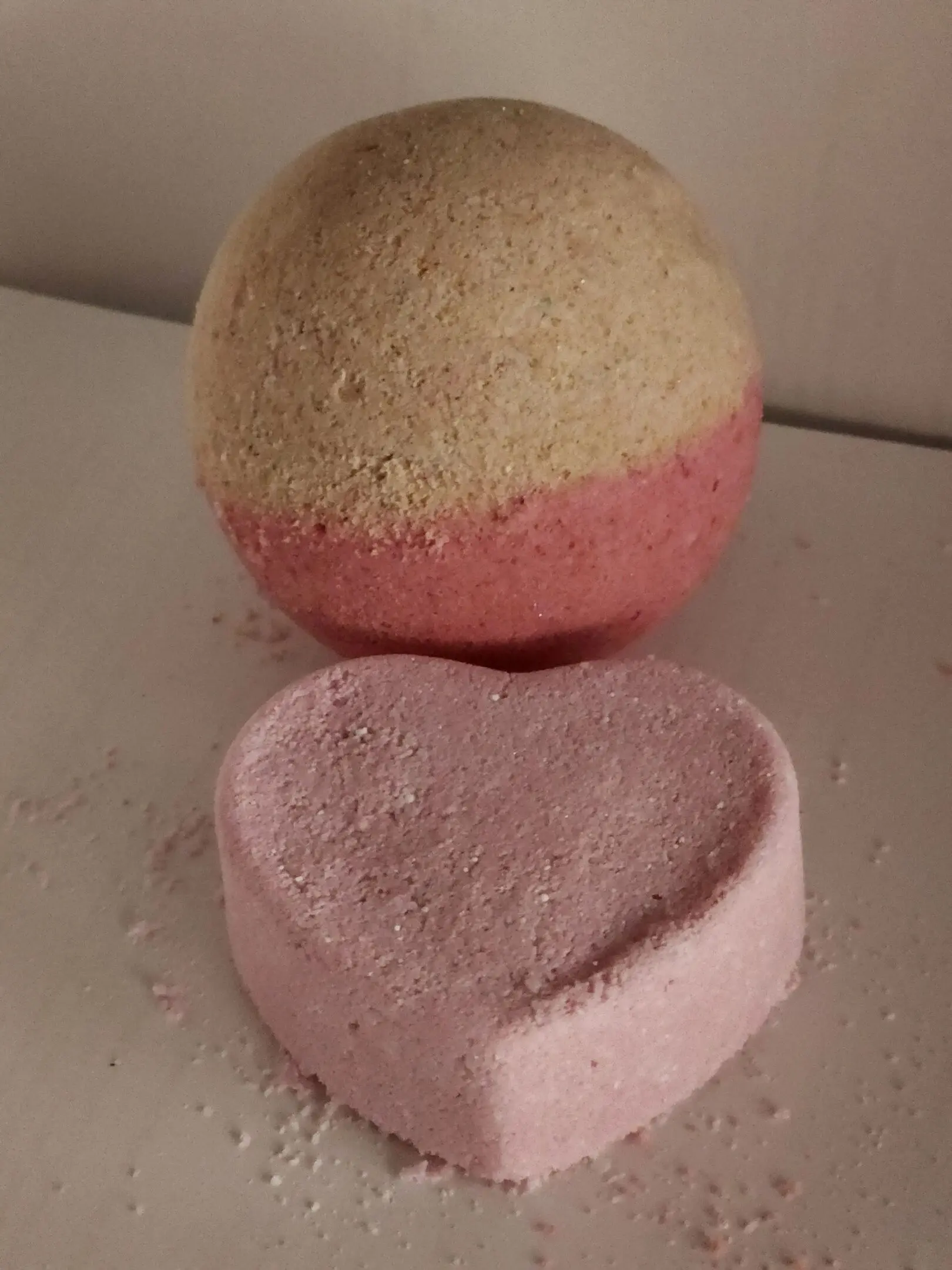 Two bath bombs are sitting next to each other.
