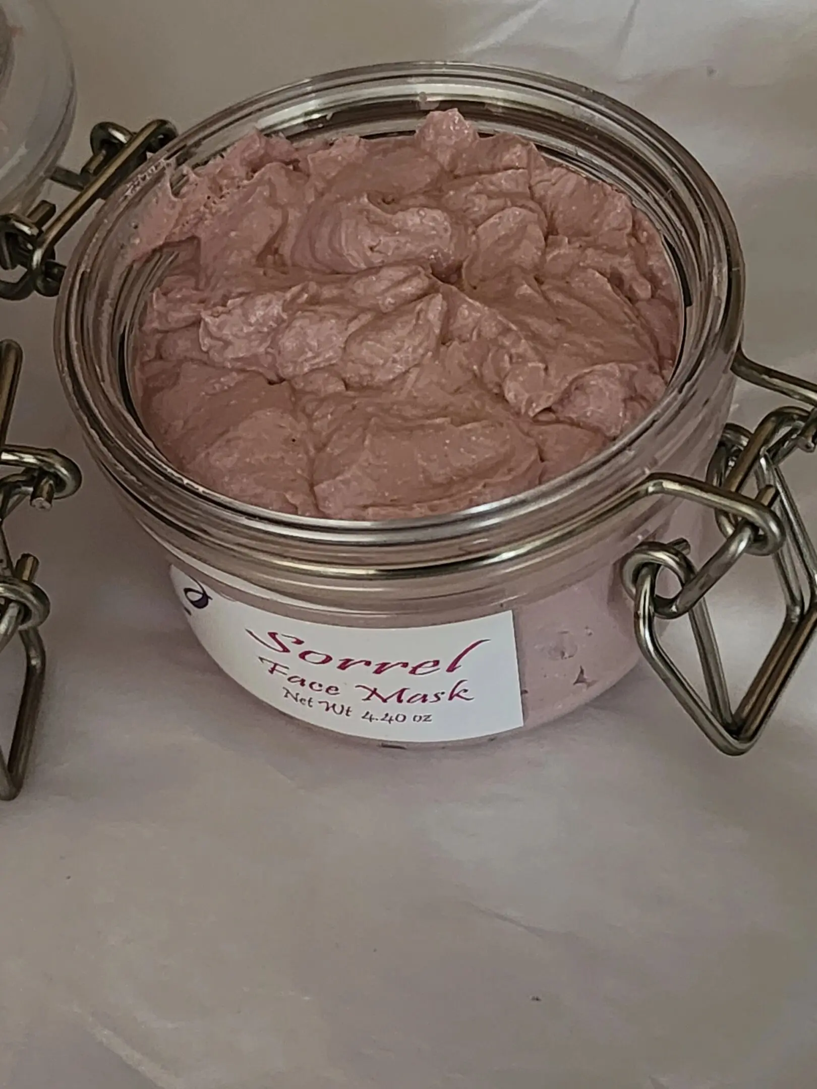 A jar of face mask sitting on top of a counter.