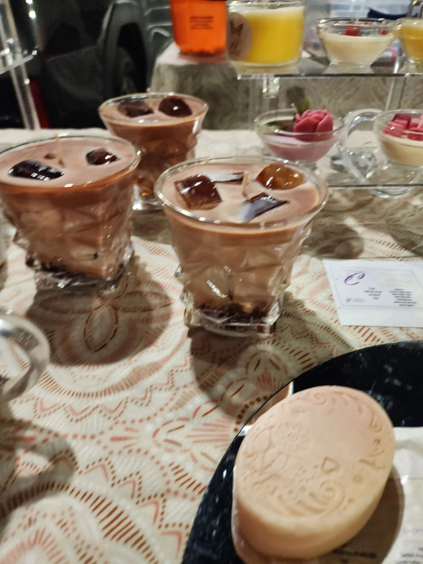 A table with three glasses of chocolate pudding.