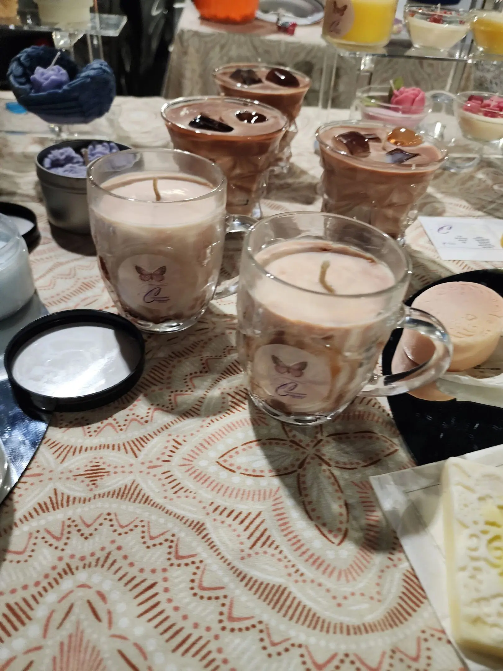 A table with candles and cups on it