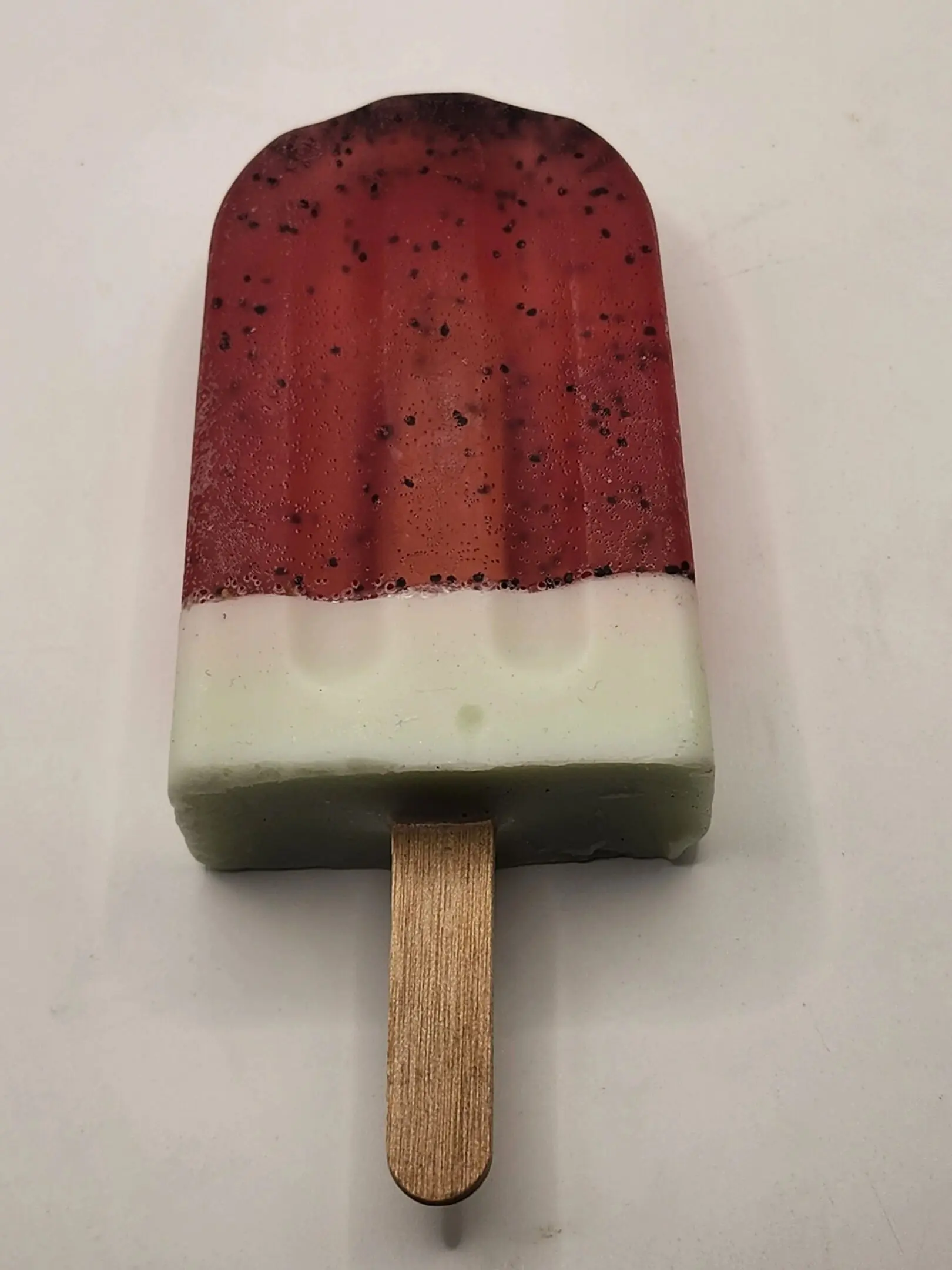 2025-02-04-12.39.03 A popsicle with red and white icing on top.