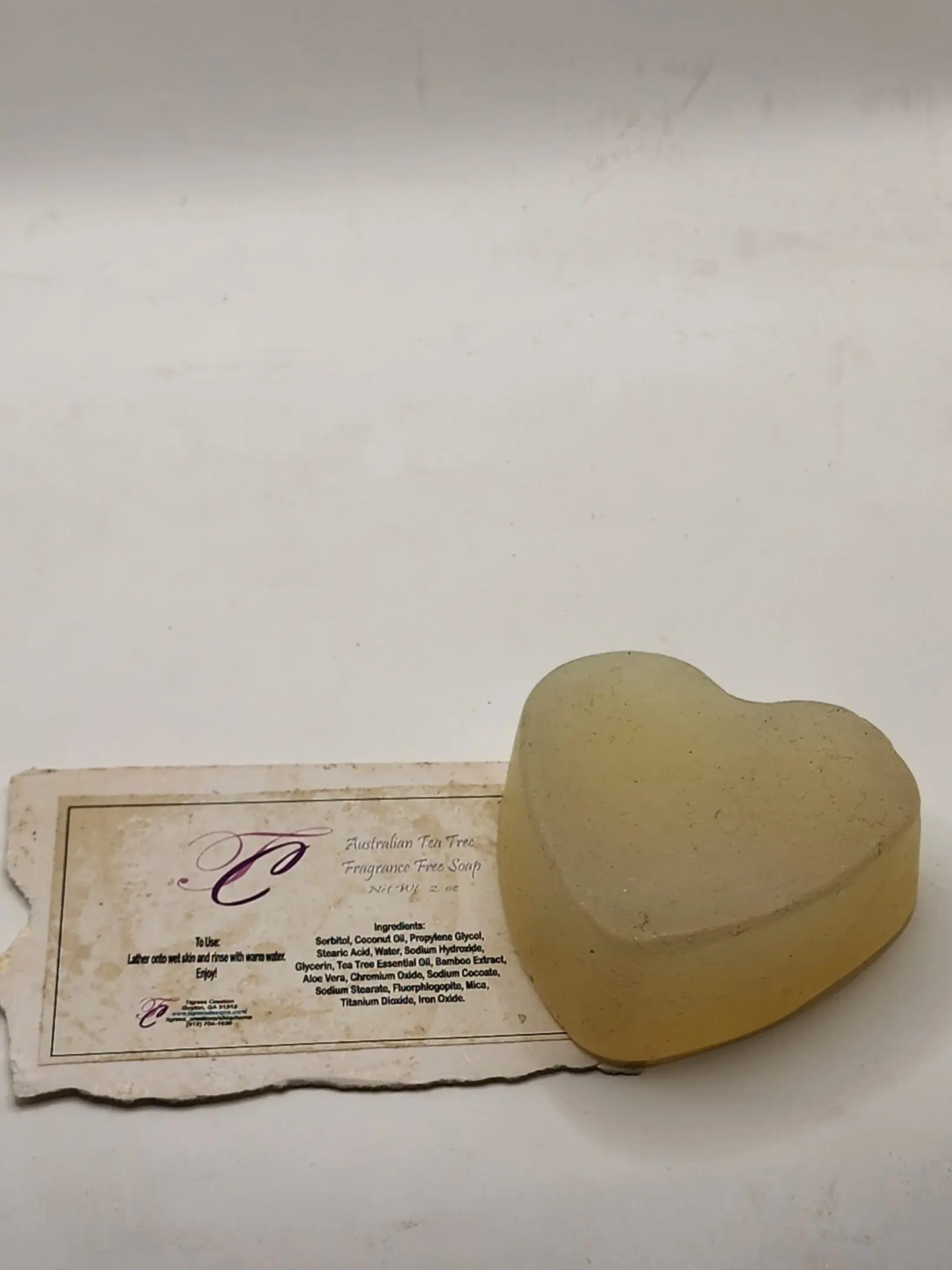A heart shaped soap sitting on top of a card.