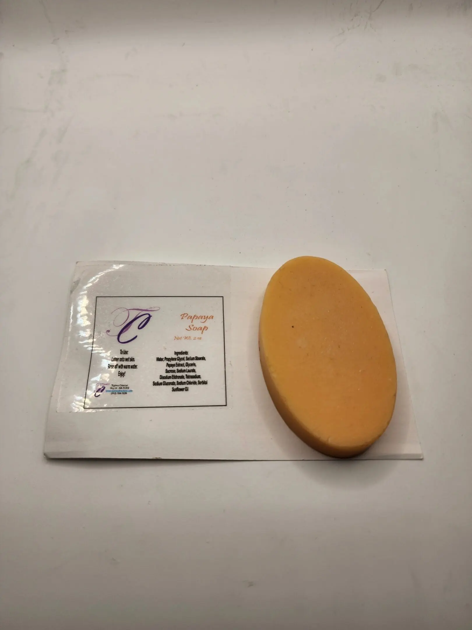 A piece of cheese sitting on top of a white paper.