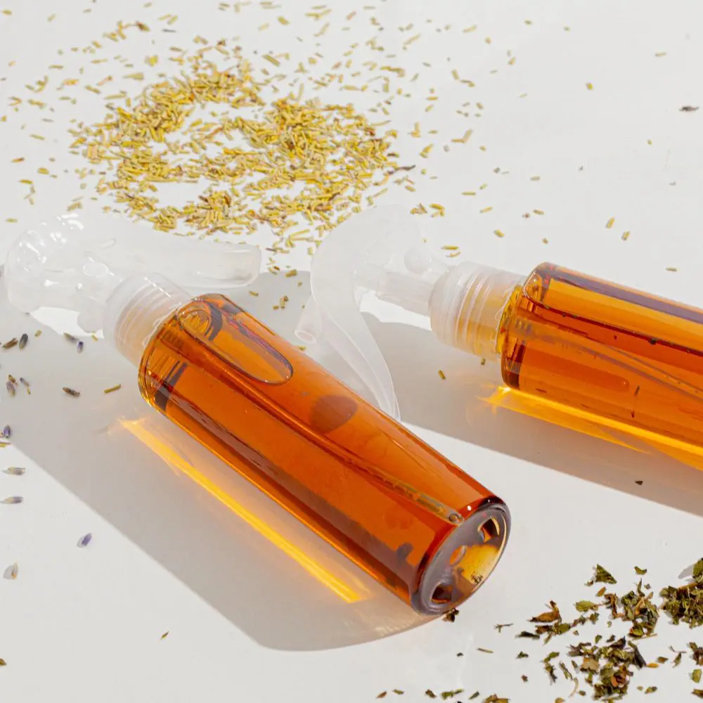 Two bottles of liquid and some small pieces of yellow material