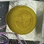 A yellow soap sitting on top of foil.