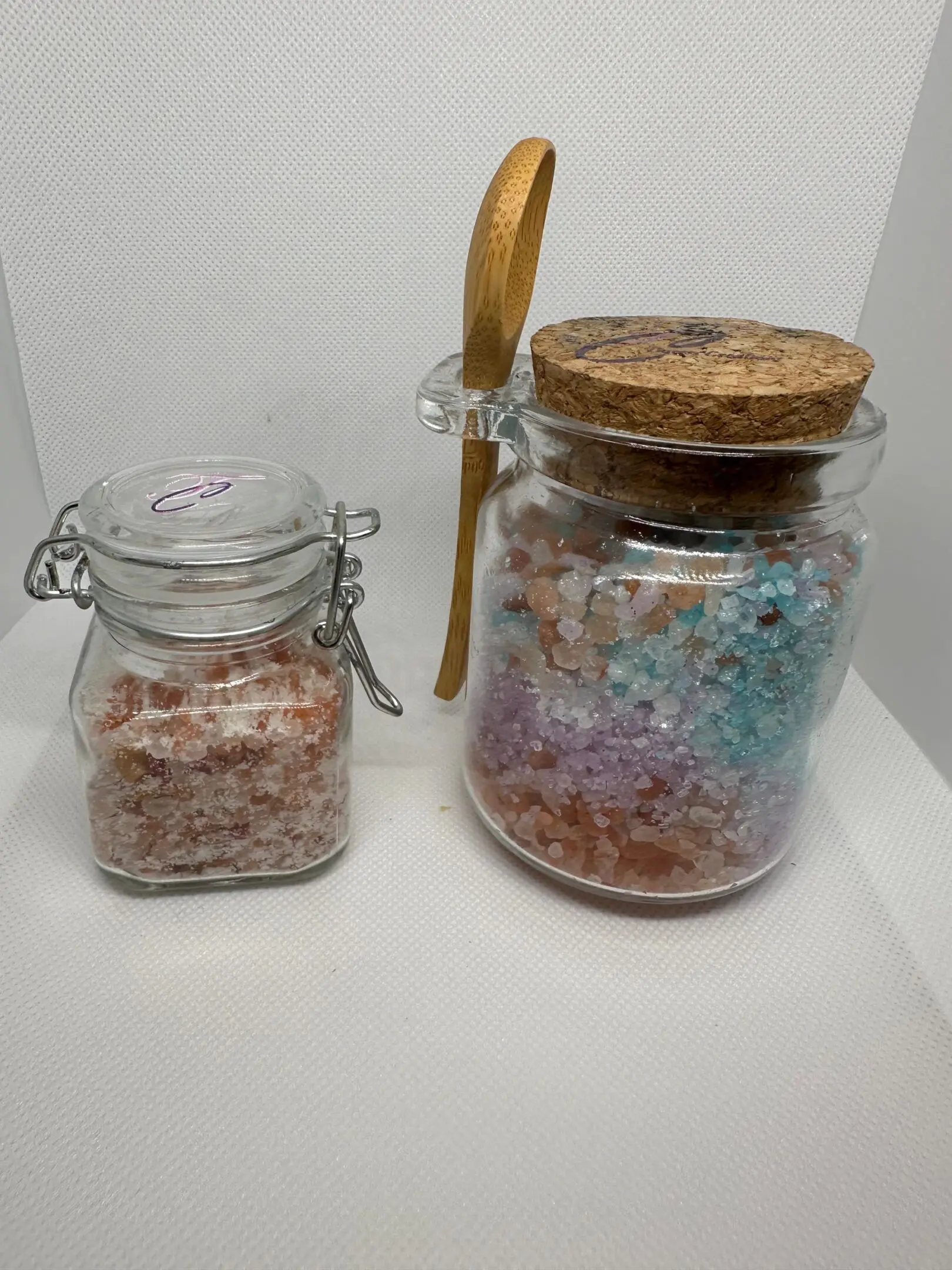 Two jars of salt and a wooden spoon