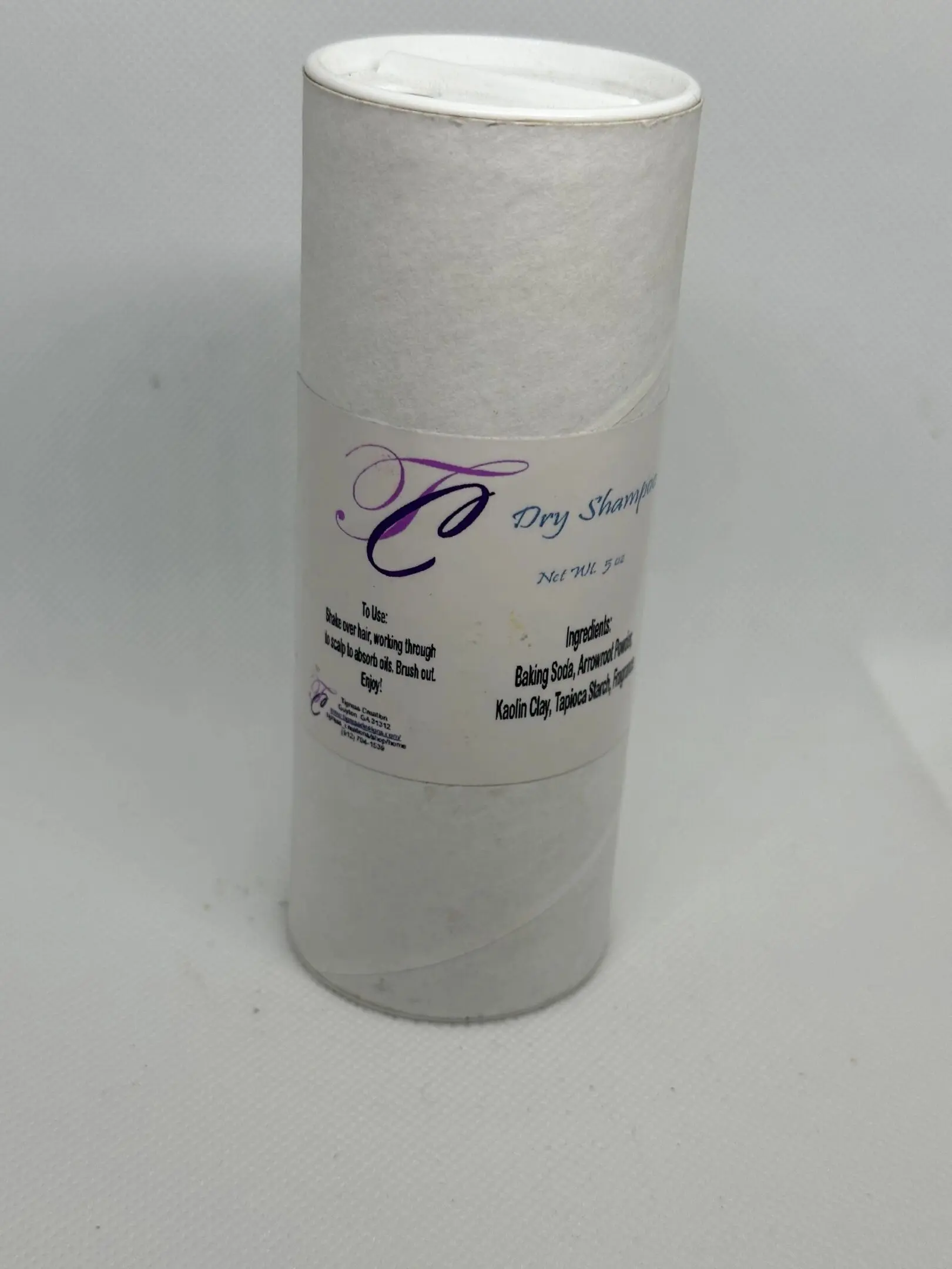 A white candle with the label dry shampoo.
