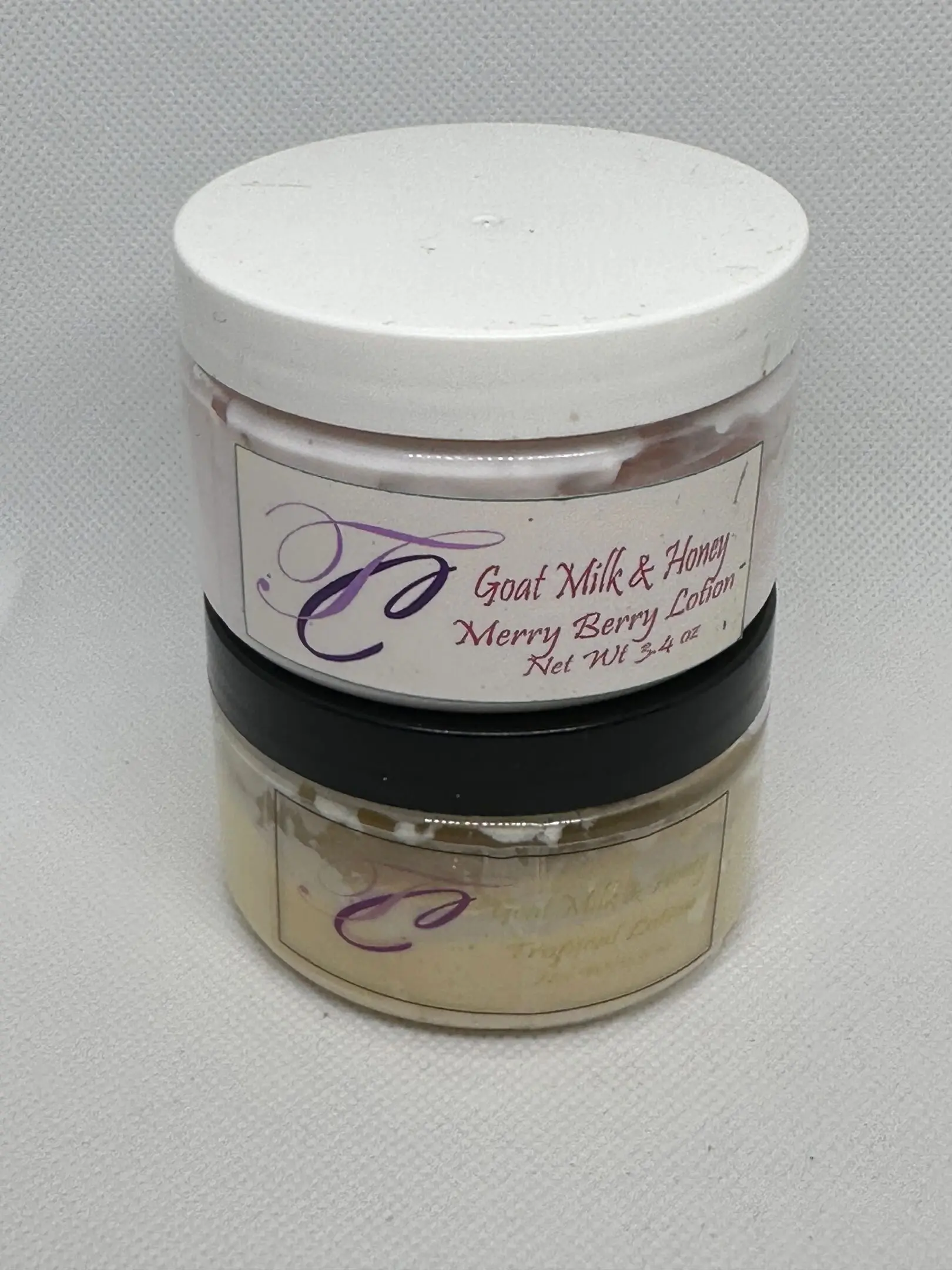 A jar of goat milk and honey is sitting on the counter.