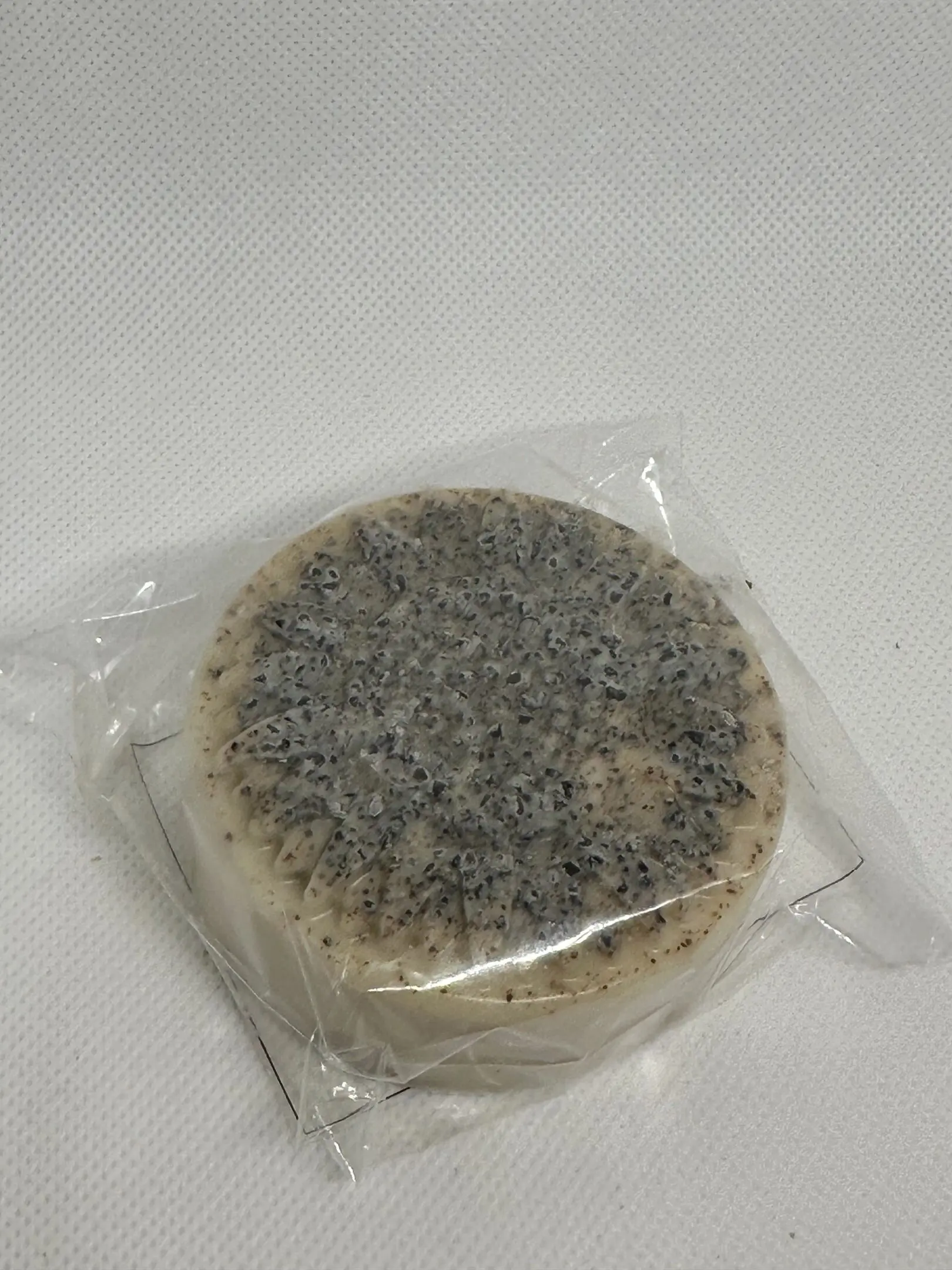 A round cake with some type of topping on top