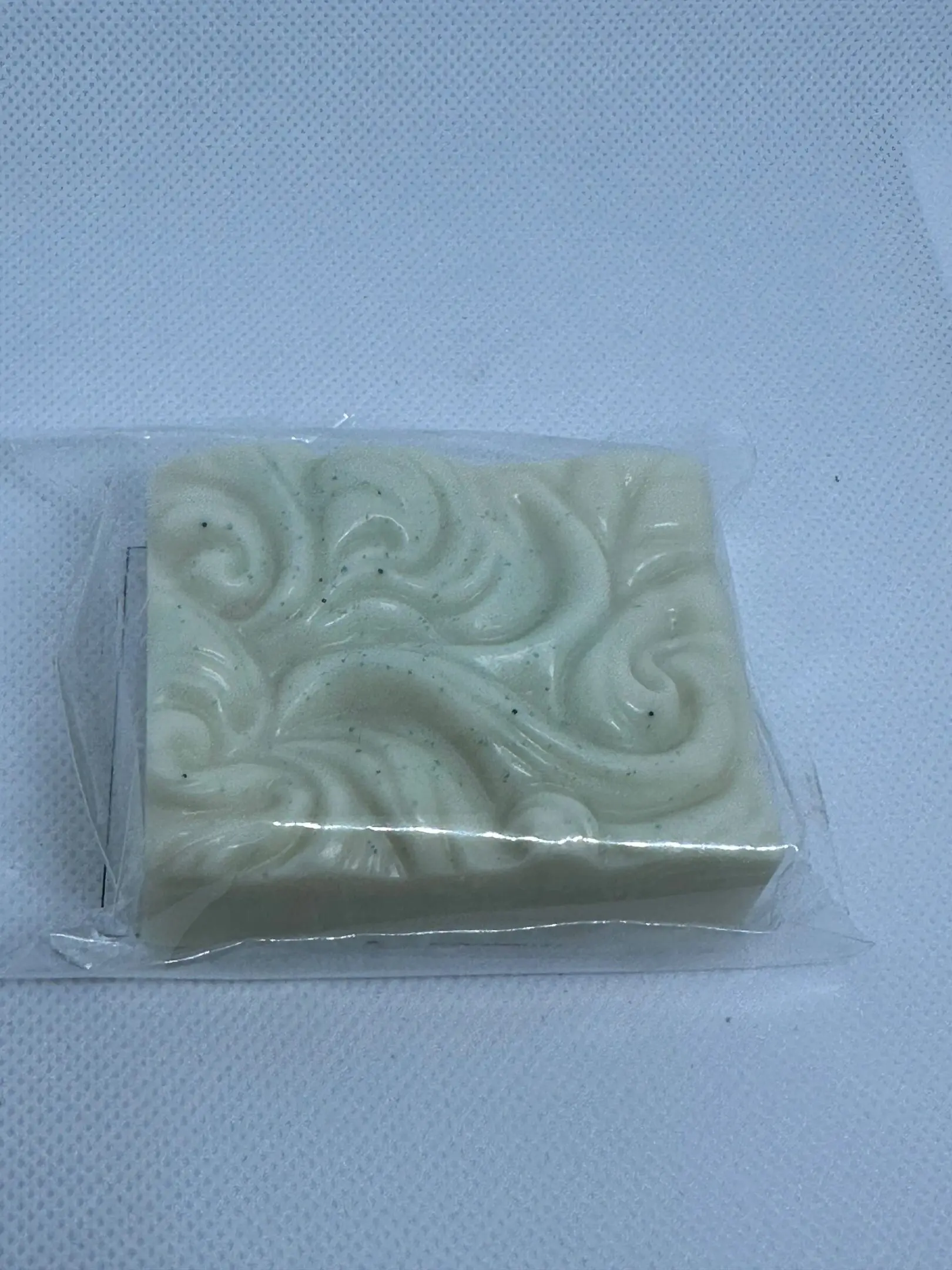 A white soap sitting on top of a plastic bag.