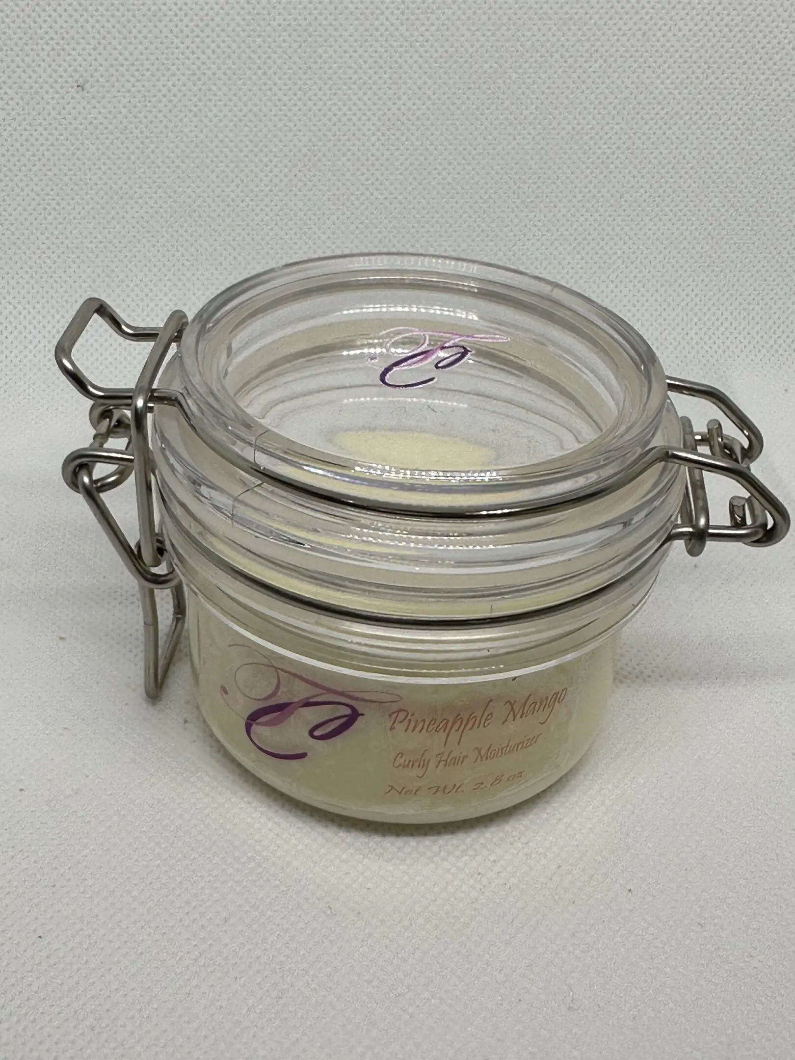 A jar of cream sitting on top of a table.