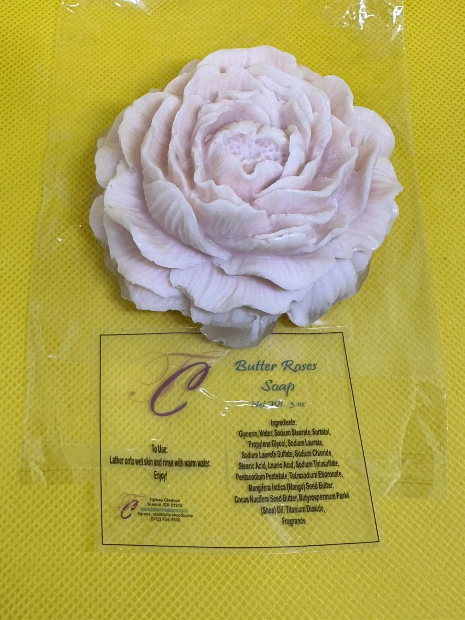 A white flower sitting on top of a yellow table.