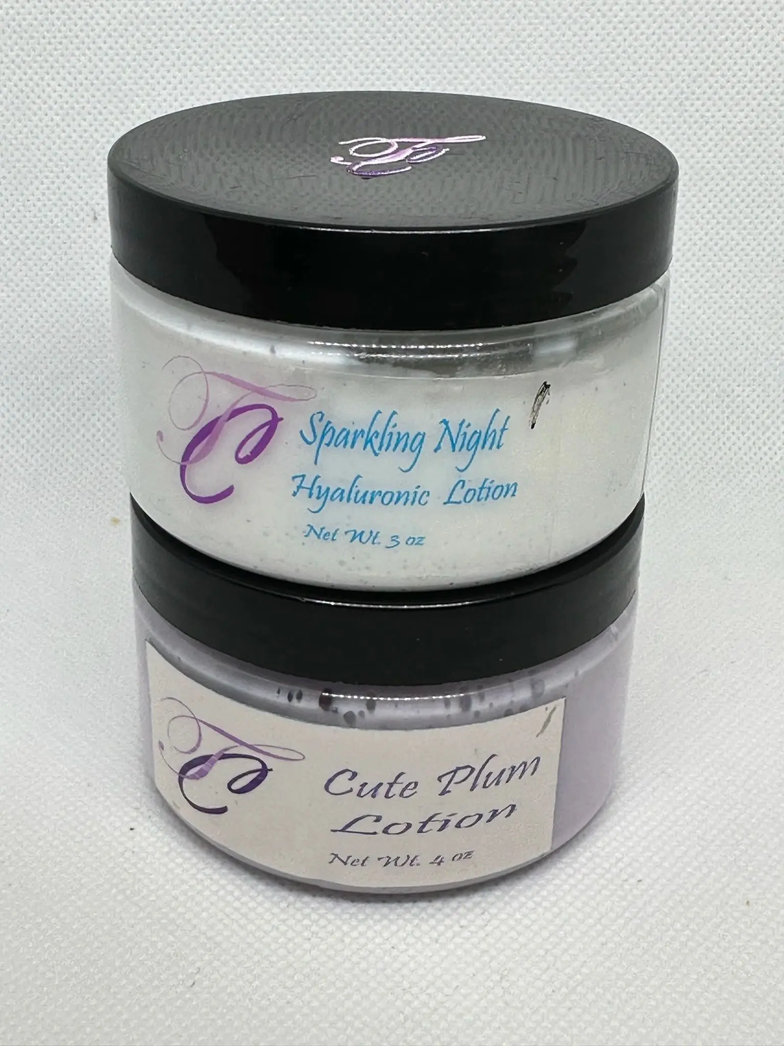 A jar of lotion and a container of sparkling night hydramine.