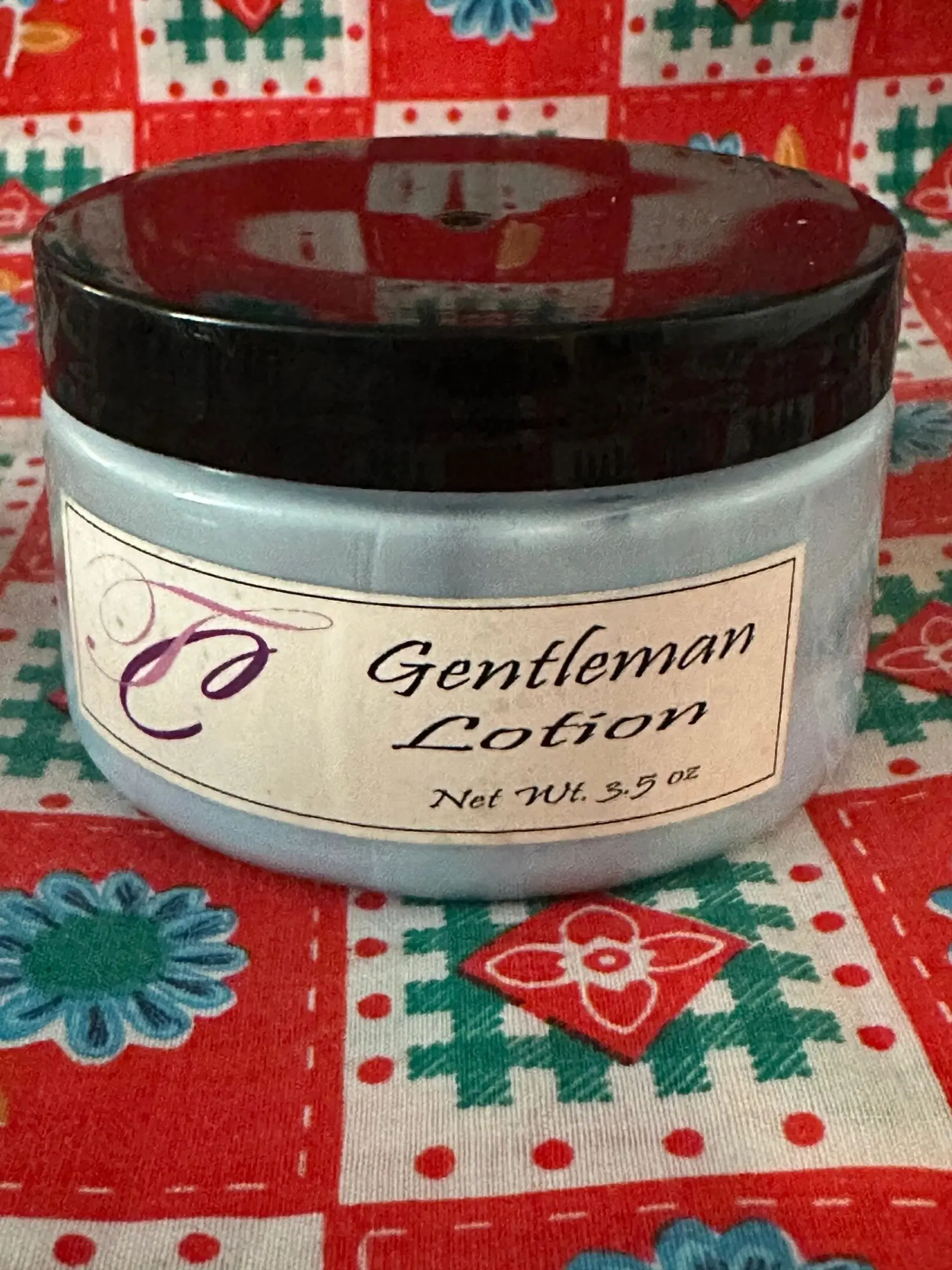 A jar of lotion sitting on top of a table.