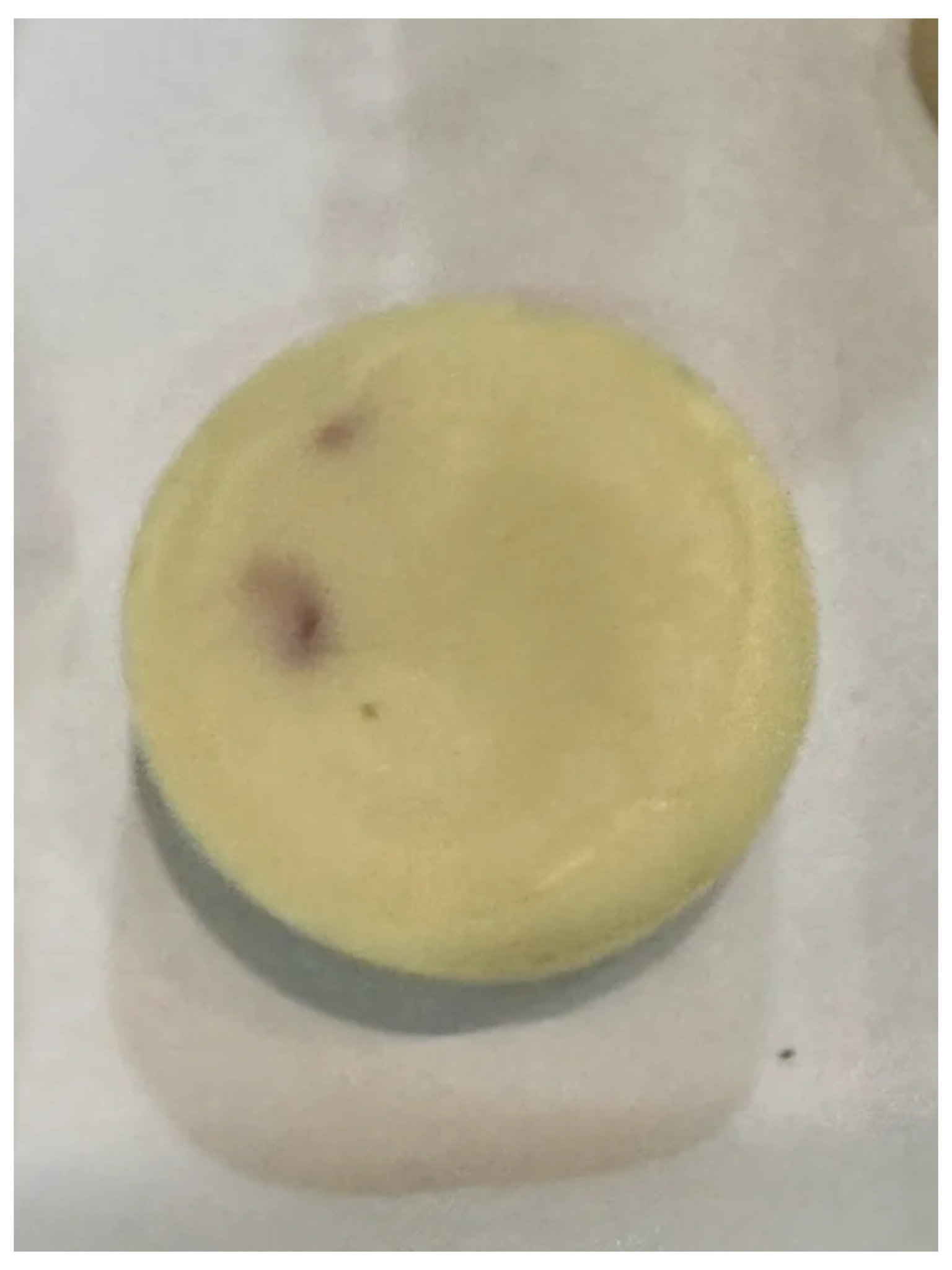 A yellow frisbee sitting on top of a table.