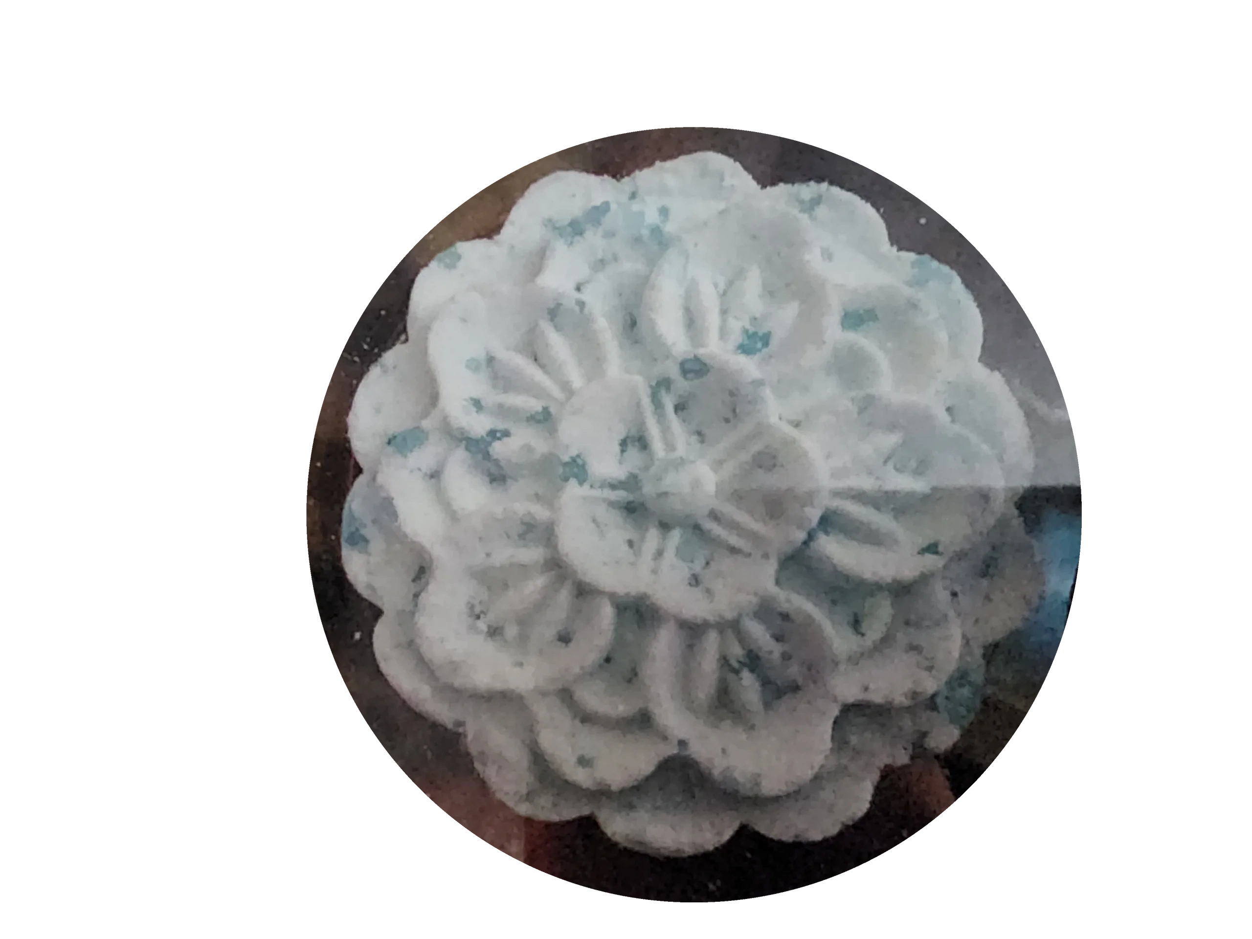 A white flower with blue spots on it.