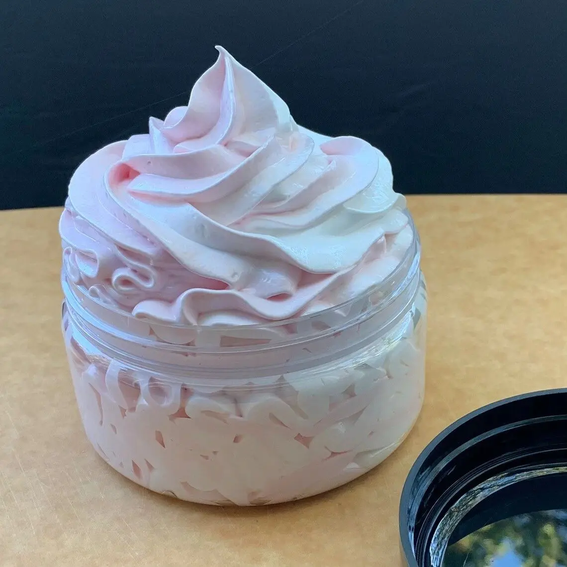 A jar of whipped cream sitting on top of a table.