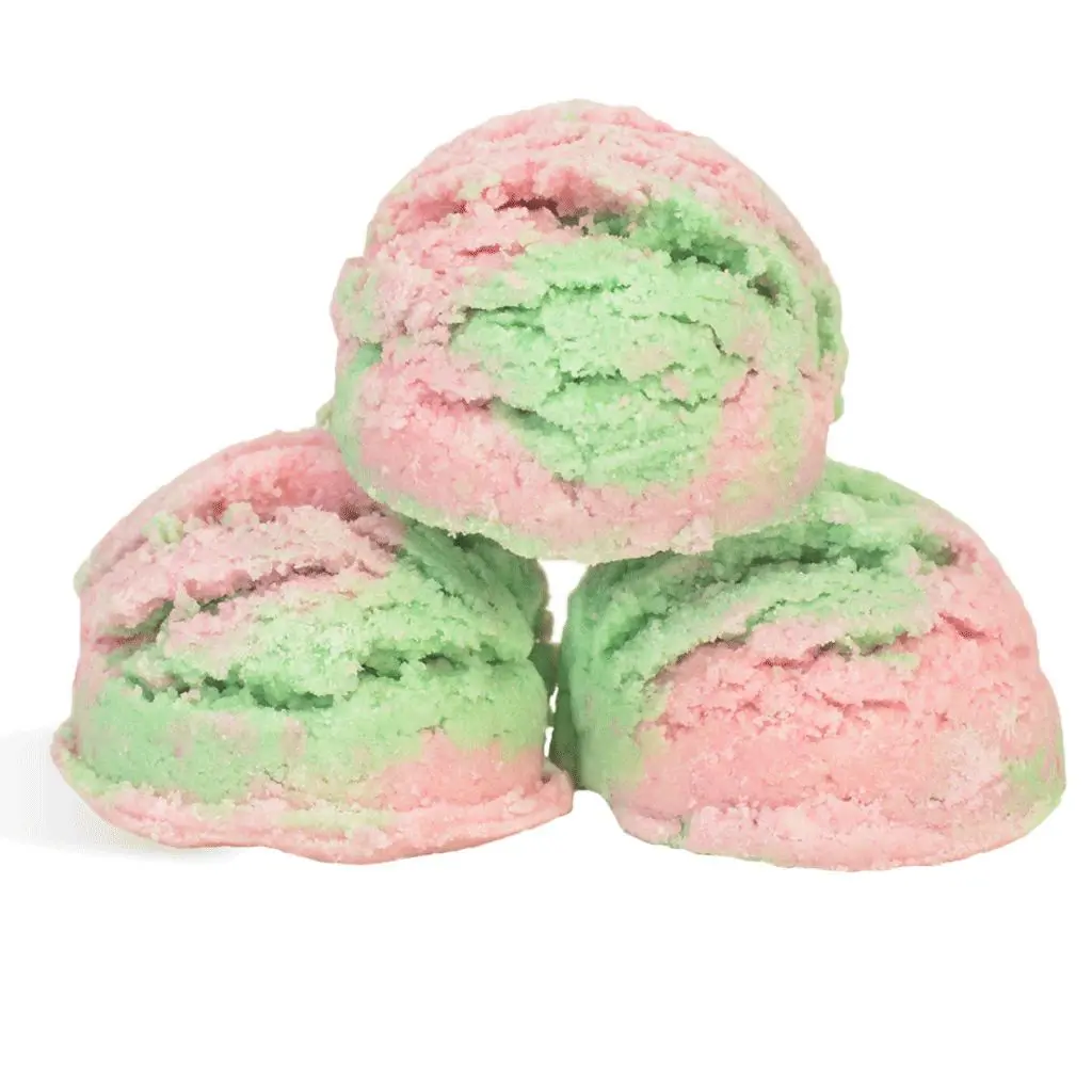 Three scoops of green and pink ice cream.