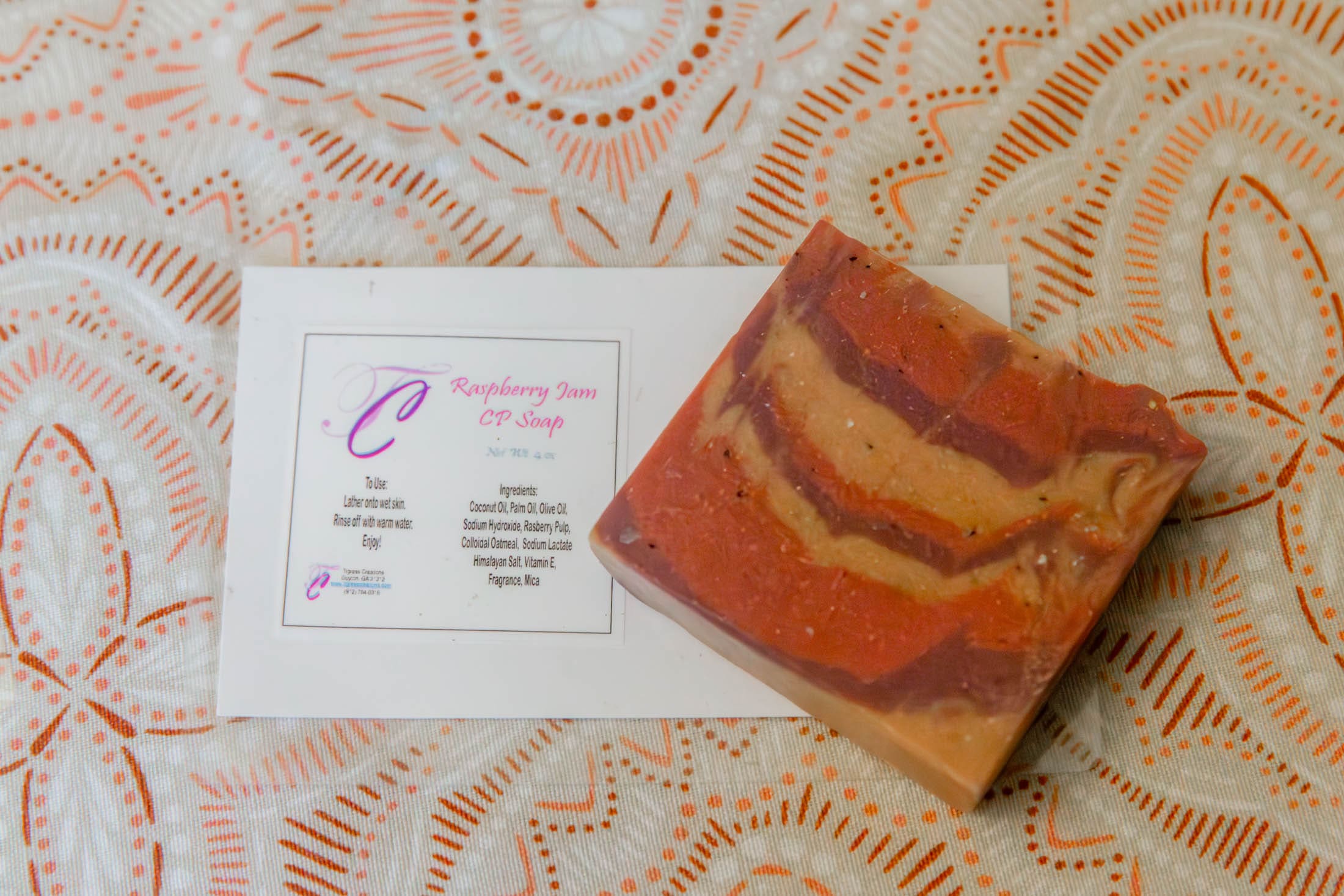 Handmade soap and label on patterned fabric.