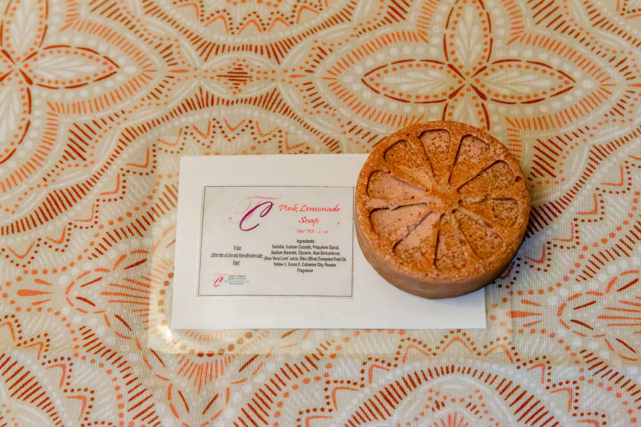 Round soap with orange slice design.