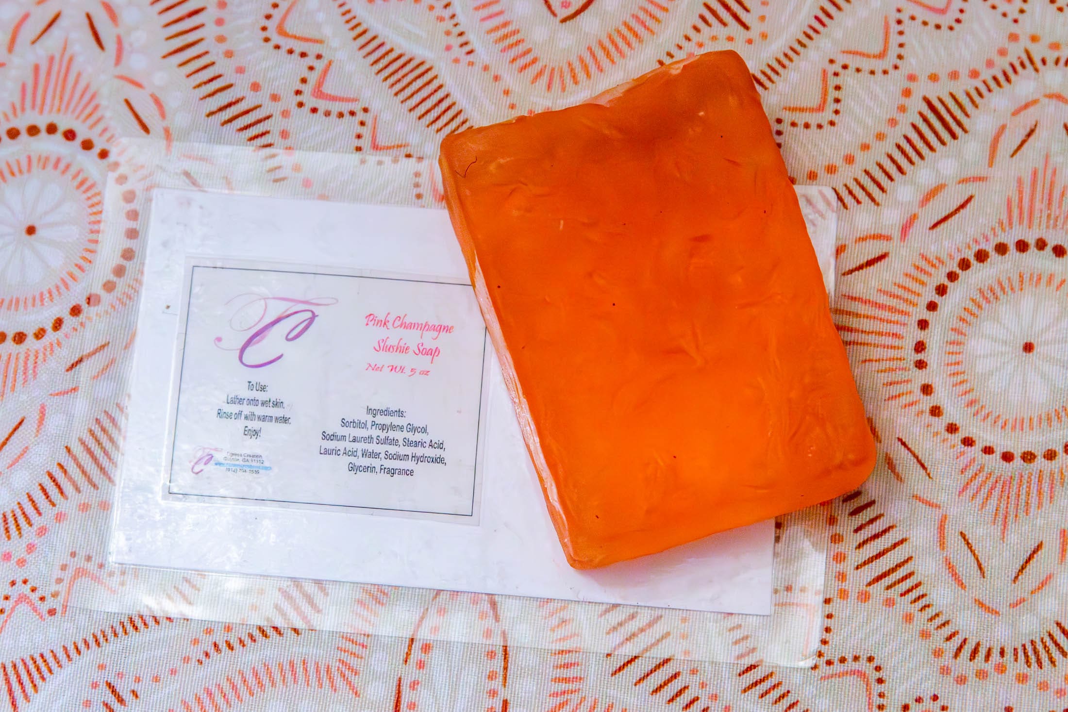 Orange soap on patterned background.